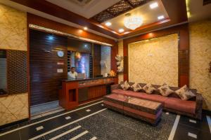 a living room with a couch and a television at Hotel Kiaara in Varanasi
