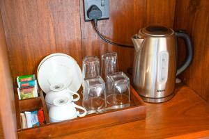 a counter with a coffee maker and a tea kettle at Darlina Hiriketiya in Hiriketiya
