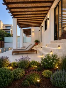 an outdoor patio with a wooden pergola and plants at athanasia sea view home front house in Polychrono