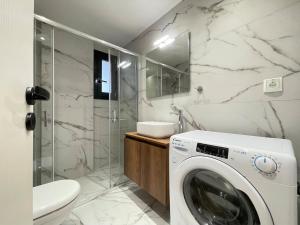 a washing machine in a bathroom with a shower at Athenean Gem Near Metro Mall in Athens +41 photos
