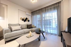 a living room with a couch and a table at Athenean Gem Near Metro Mall in Athens