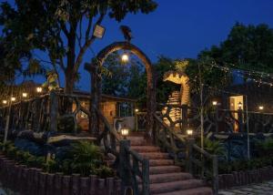 a set of stairs in front of a building with lights at Gaikar Farm & Resort in Murbād