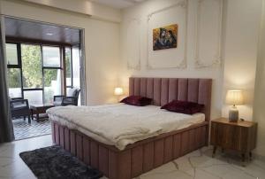 a bedroom with a large bed in a room at Gaikar Farm & Resort in Murbād +54 photos