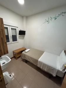 a hospital room with a bed and a sink at Hostal Delfos in Barcelona +103 photos