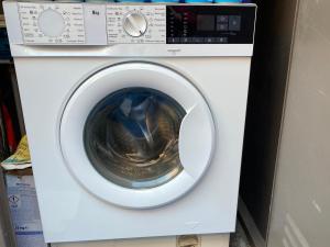 a white washing machine with its door open at Bodega Linda in Puntagorda