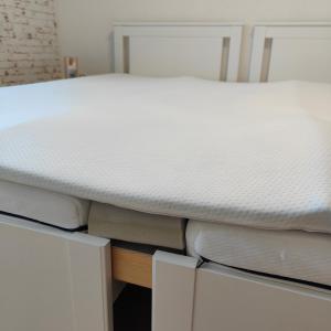 a bed sitting on top of two drawers at Ferienwohnung Einsiedler - für 4 Personen mit Terrasse und Grill in Windisch Minihof