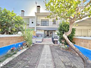a walkway in front of a house with a tree at Terrasol Zayamar in Caleta De Velez