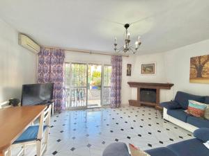 a living room with a blue couch and a fireplace at Terrasol Zayamar in Caleta De Velez
