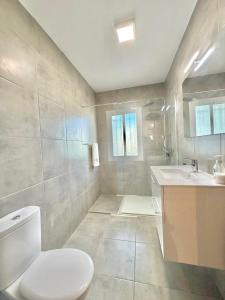 a bathroom with a toilet and a sink at Terrasol Zayamar in Caleta De Velez +3 photos