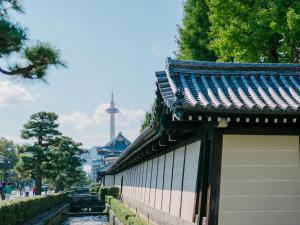 a building next to a river with a tower in the background at hotel kanra kyoto in Kyoto +86 photos