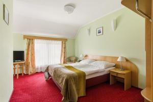 a hotel room with a bed and a window at Hotel Karczyce in Karczyce +48 photos