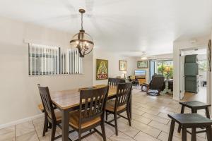 a dining room and living room with a table and chairs at Sea Woods 115 in New Smyrna Beach