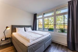 a bedroom with a bed and a large window at TouchBed in St. Gallen