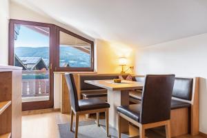 a room with a table and chairs and a large window at Apartment - Ferienwohnung Elisabeth in Radstadt