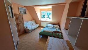 a small room with two beds and a window at Noclegi pod Brzegiem in Zawoja +53 photos