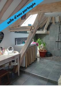 a kitchen with an attic with wooden beams at Sous les toits in Dosches