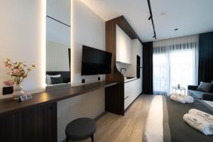 a living room with a television and a couch at Sunset Premium in Keramoti