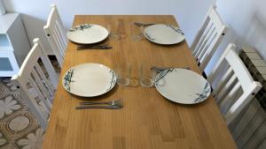 a dining room table with plates and glasses on it at Luisa in Malgrat de Mar