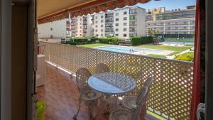 a patio with a table and chairs on a balcony at Luisa in Malgrat de Mar