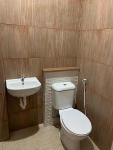 a bathroom with a toilet and a sink at Sera INN Cikarang in Jatirarangan
