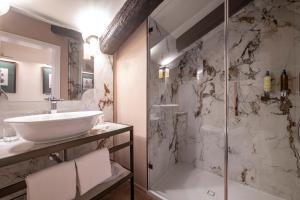 a bathroom with a sink and a shower at Palazzo De Polo in Venice