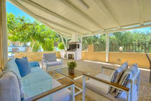 a patio with a couch and a table at Nautilus Villa - Private Pool in Elaía