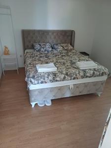a bedroom with a bed with two towels on it at Apartman Miljan in Trebinje
