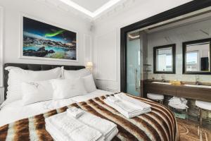 a bedroom with a large bed and a bathroom at Diamond Suites by Reykjavik Keflavik Airport in Keflavík +97 photos