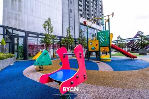 a playground with different colored slides and swings at Premium Suites D'lement Genting Highlands by BYON in Genting Highlands
