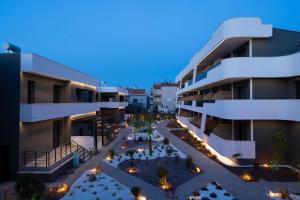 an apartment building with a courtyard at night at Sunset Premium in Keramoti