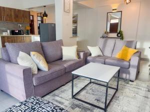 a living room with two couches and a coffee table at The palace001 in Mombasa