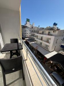 a balcony with a table and a view of a city at Holiday Hotel in Erdemli