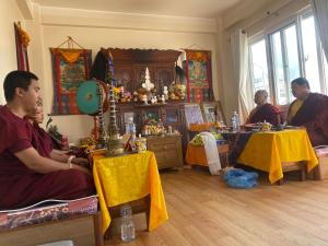 a group of monks sitting in a room at Monastery View Homestay in Kathmandu