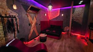 a living room with a couch and red lights at Magik Love Apartament in Piła