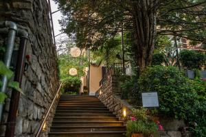 a set of stairs leading up to a building with lights at Le Funi Hotel in Bergamo