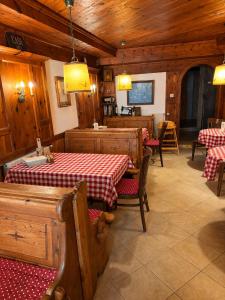 a restaurant with two tables and chairs and wooden walls at Café Pension Leopoldine in Hallstatt