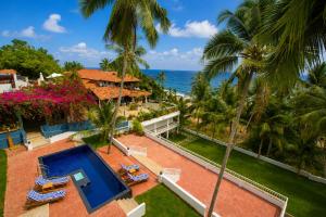 an aerial view of a resort with a swimming pool and the ocean at Getaway Beach Resort Kovalam in Kovalam