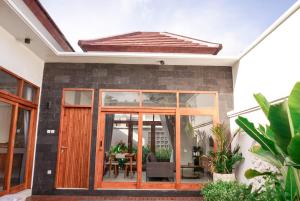 a house with a conservatory with sliding glass doors at Selena Home Tropical Villa Jimbaran in Jimbaran