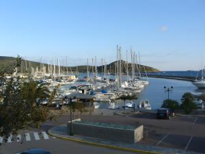 a marina with many boats in the water at Appart avec terrasse proche mer in Macinaggio