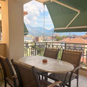 a table and chairs on a balcony with a view at Dais Apartments in Mitika
