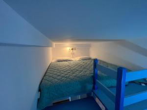 a bed in a room with a blue light at Choios' House in Kondoliánika