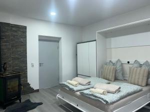 a bedroom with a large mirror and a bed with pillows at Schöne Ferien- und Monteurwohnung in Ennepetal +3 photos