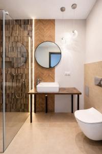 a bathroom with a sink and a mirror at Pełnia Mazur in Pasym