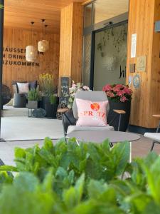 a pink pillow on a chair in front of a store at Apart & Suiten Hotel WEIDEN in Schladming
