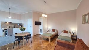 a living room with a bed and a table in a room at ENKLAWA Apartamenty in Przemyśl