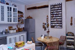a kitchen with a table and a refrigerator at Dar Halima in Rabat