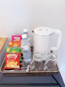 a tray with a blender and some food and water at Albus resort Kohlarn in Ko Larn