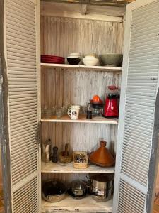 a pantry filled with lots of pots and pans at Beach House with Sea Views and Rooftop Terrace in Sidi Kaouki