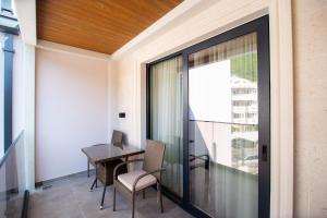 a dining room with a table and chairs on a balcony at Premium Apartments Zevs in Budva