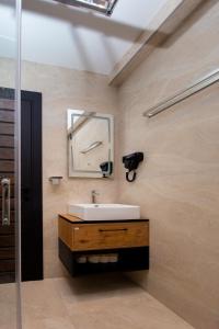 a bathroom with a sink and a mirror at Premium Apartments Zevs in Budva +75 photos